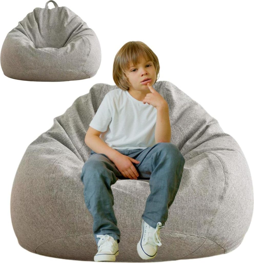 A young boy sits on a large, light gray beanbag chair. Another beanbag chair is shown in the background.