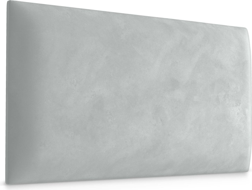 A light gray upholstered headboard or wall panel with a textured surface.