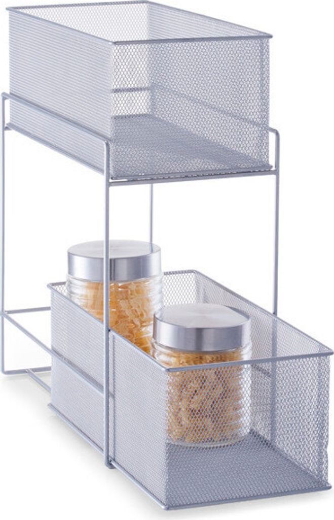A two-tiered silver mesh organizer with two glass jars filled with pasta on the bottom shelf.