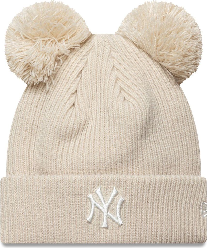 A beige knitted winter hat with two pom-poms on top and the New York Yankees logo on the front.