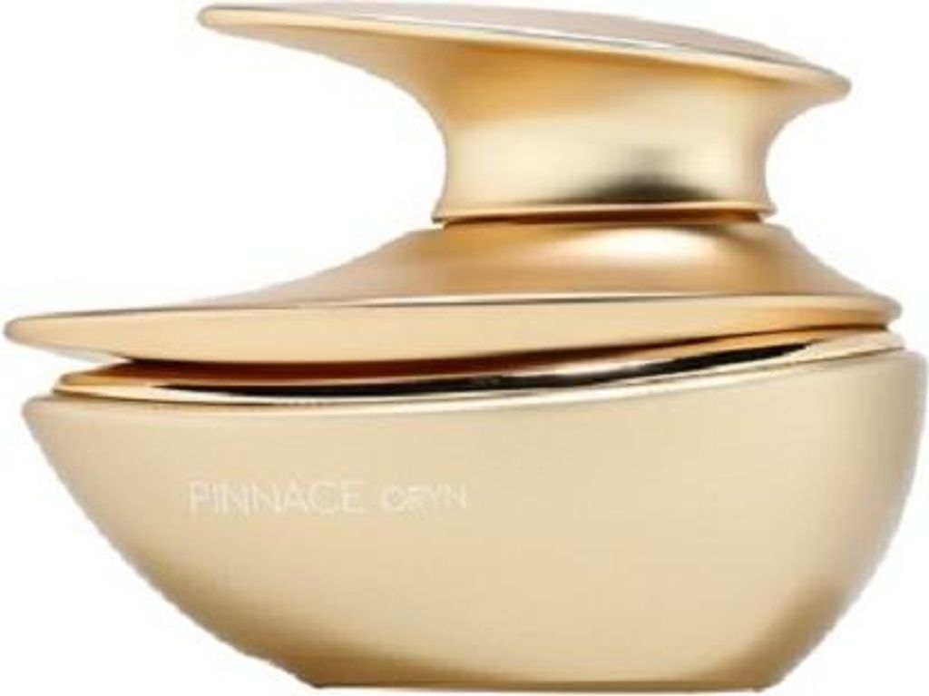 A gold-colored perfume bottle with a unique, sculptural design.