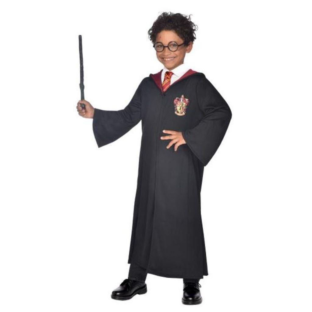 A child dressed as Harry Potter holding a wand.