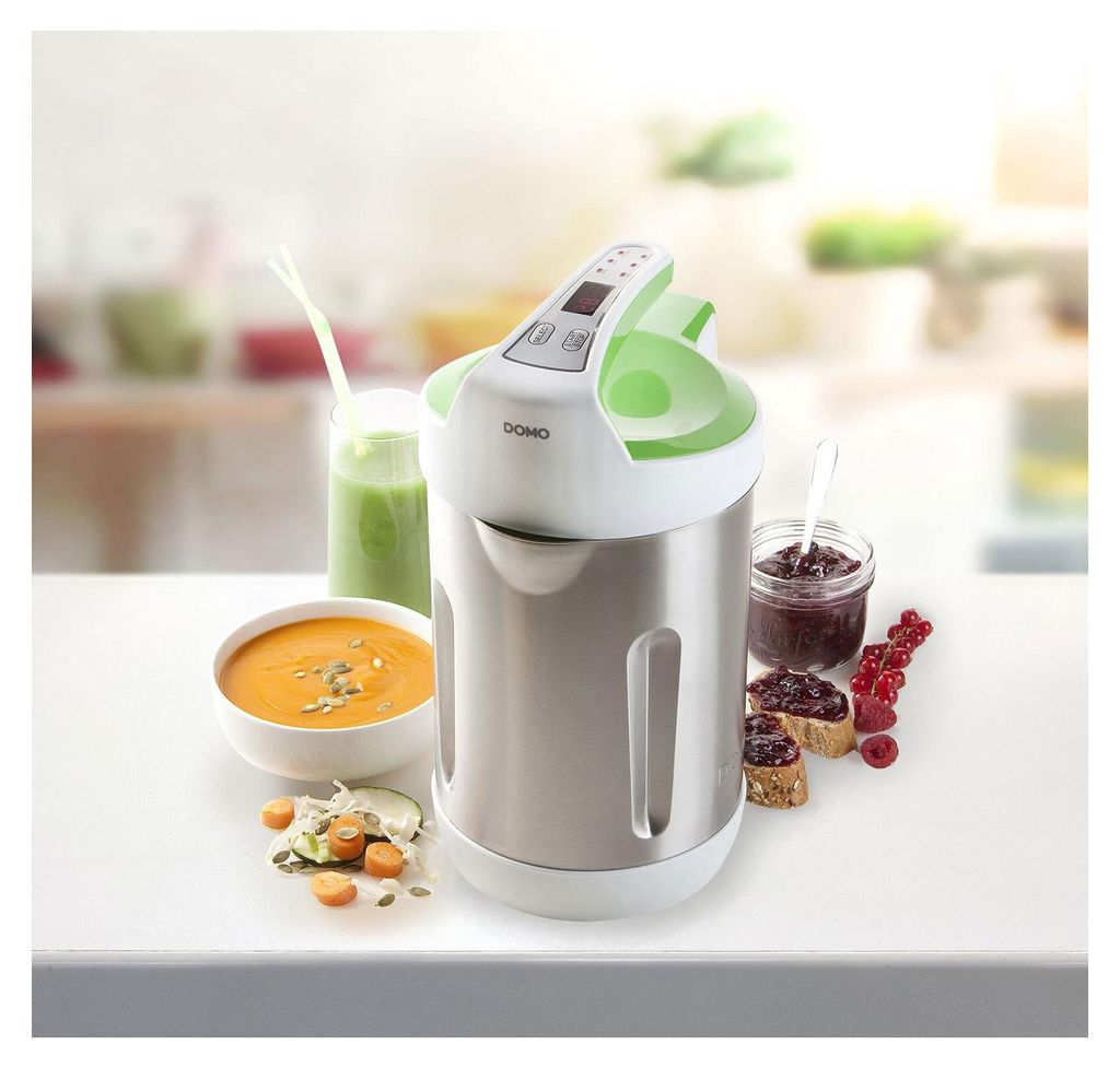 A soup maker is shown on a table with prepared food items like soup, jam on toast, and a smoothie.