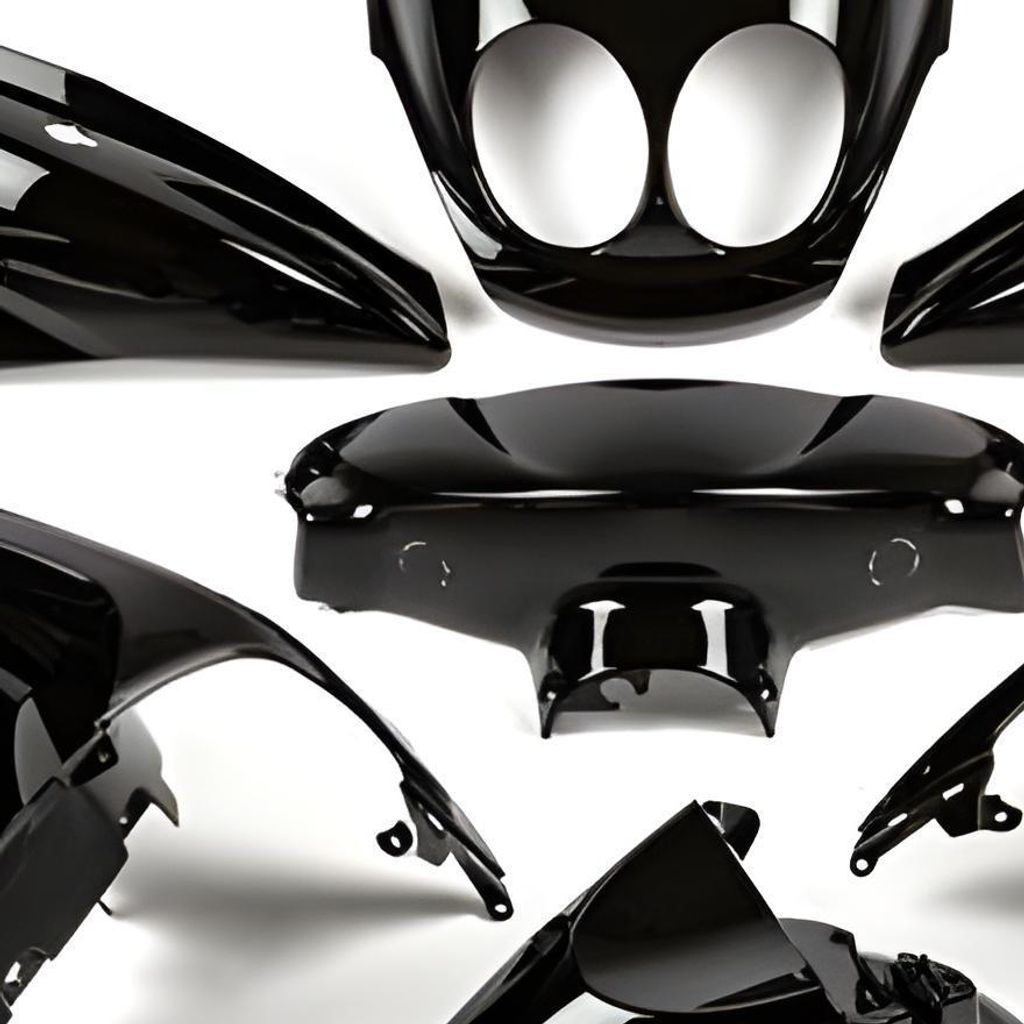 A collection of black motorcycle fairing parts arranged against a white background.