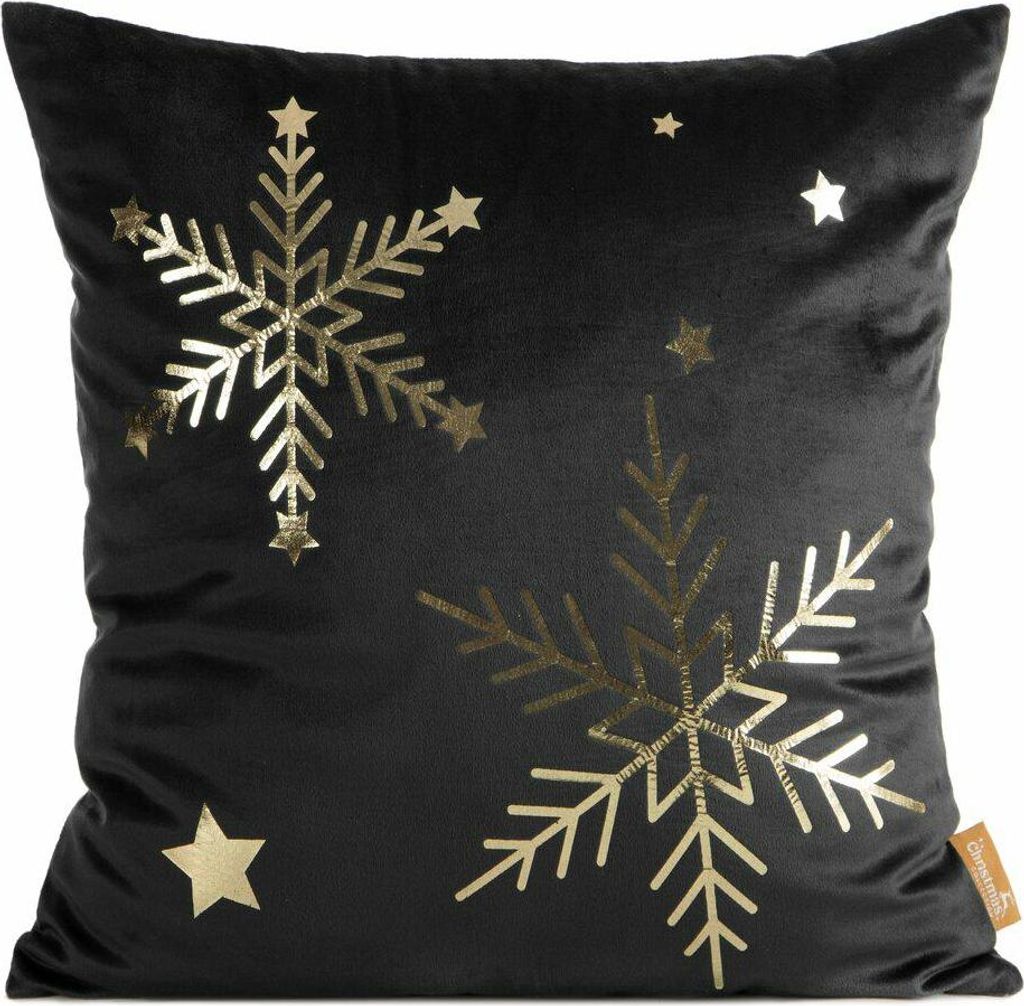 A black pillow with gold snowflake and star designs.