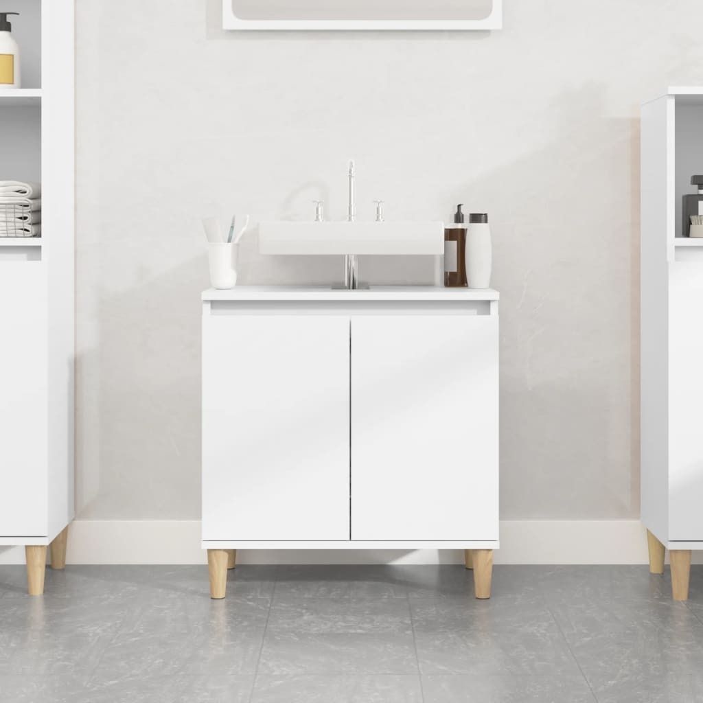 A white bathroom vanity with a sink and faucet, set against a textured white wall and a gray tiled floor.