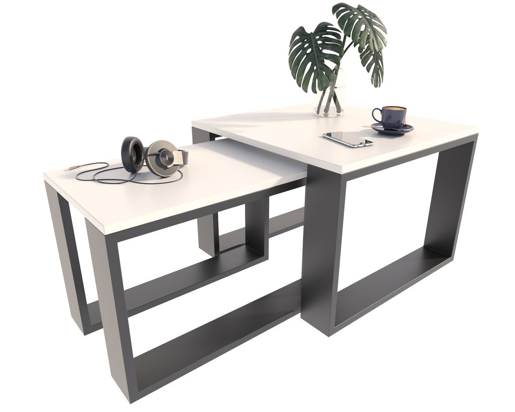 Two nesting coffee tables with a plant, headphones, and a coffee cup on them.