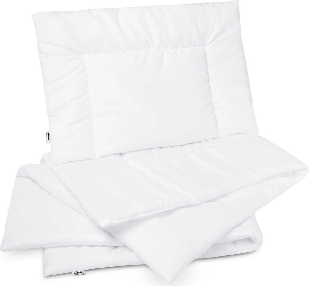 A white duvet and pillow set folded and stacked.