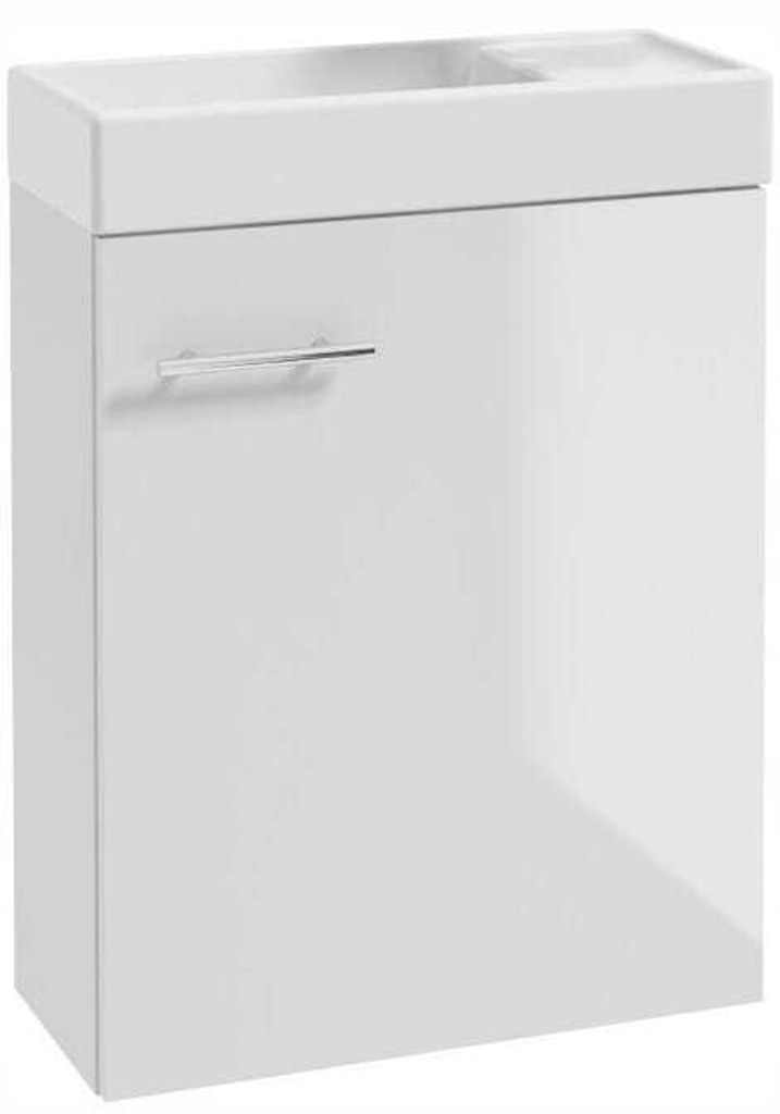 A white bathroom vanity with a sink and a chrome handle.