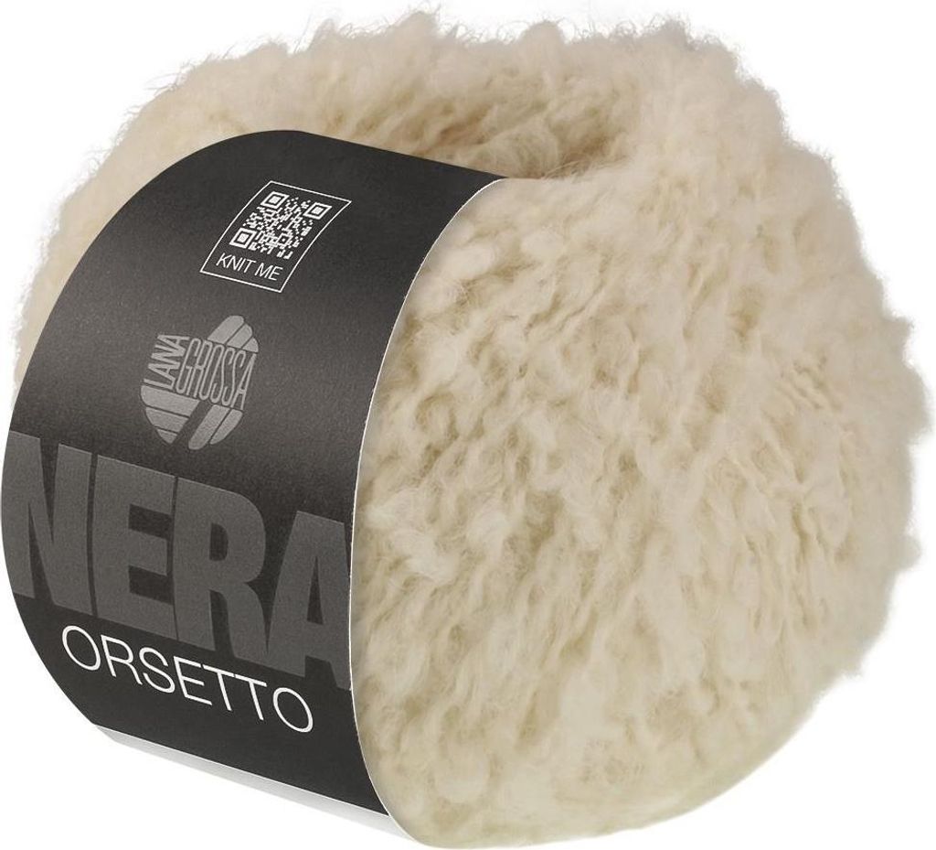 A ball of fluffy, cream-colored yarn with a black label wrapped around it.