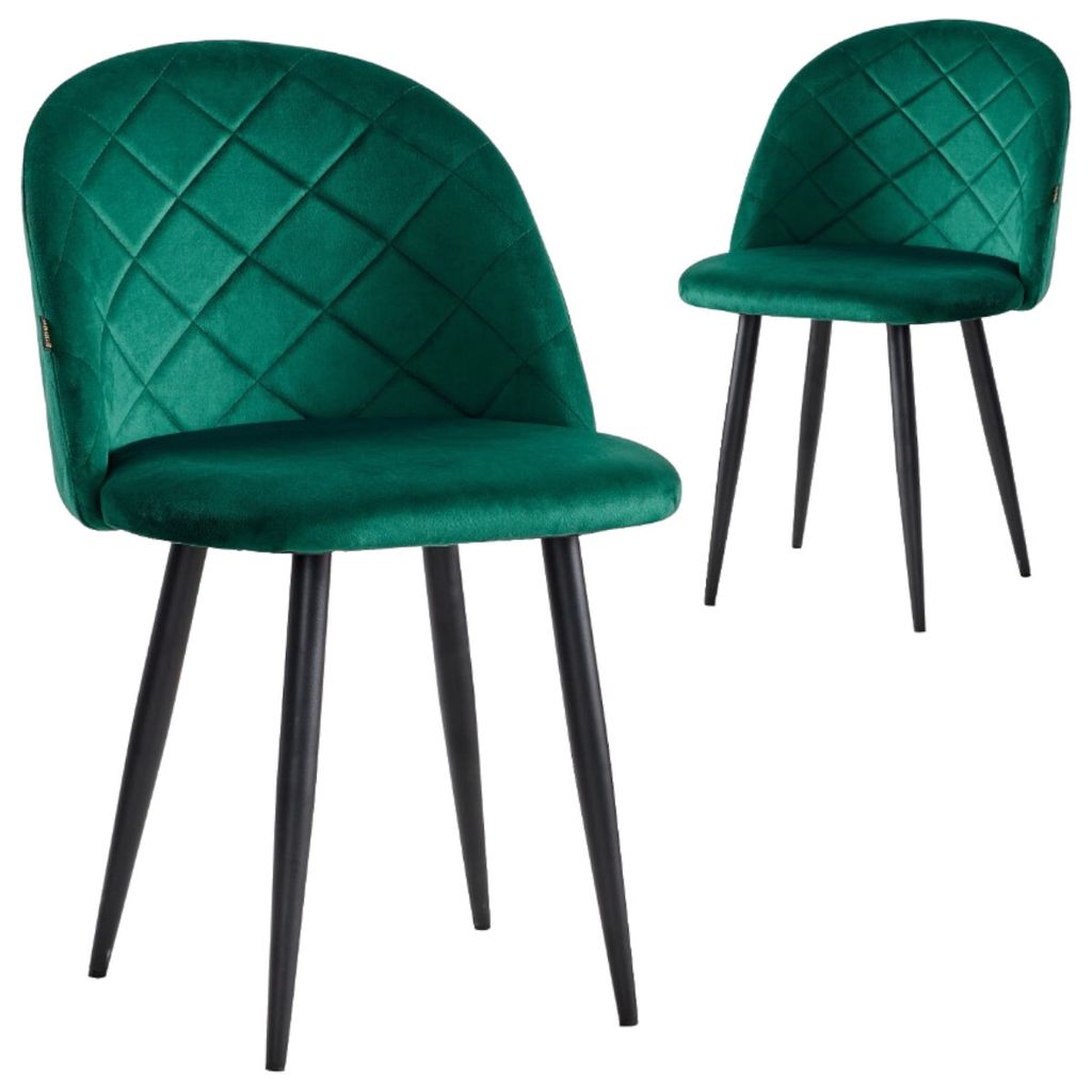Two dark green velvet dining chairs with black metal legs are shown against a white background. The chair in the foreground is angled slightly towards the viewer, while the chair in the background is positioned further back and to the right.