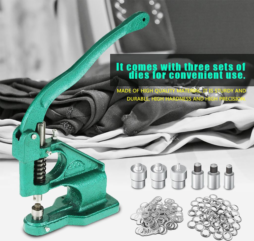 A green manual eyelet press machine with various accessories and fabric in the background.