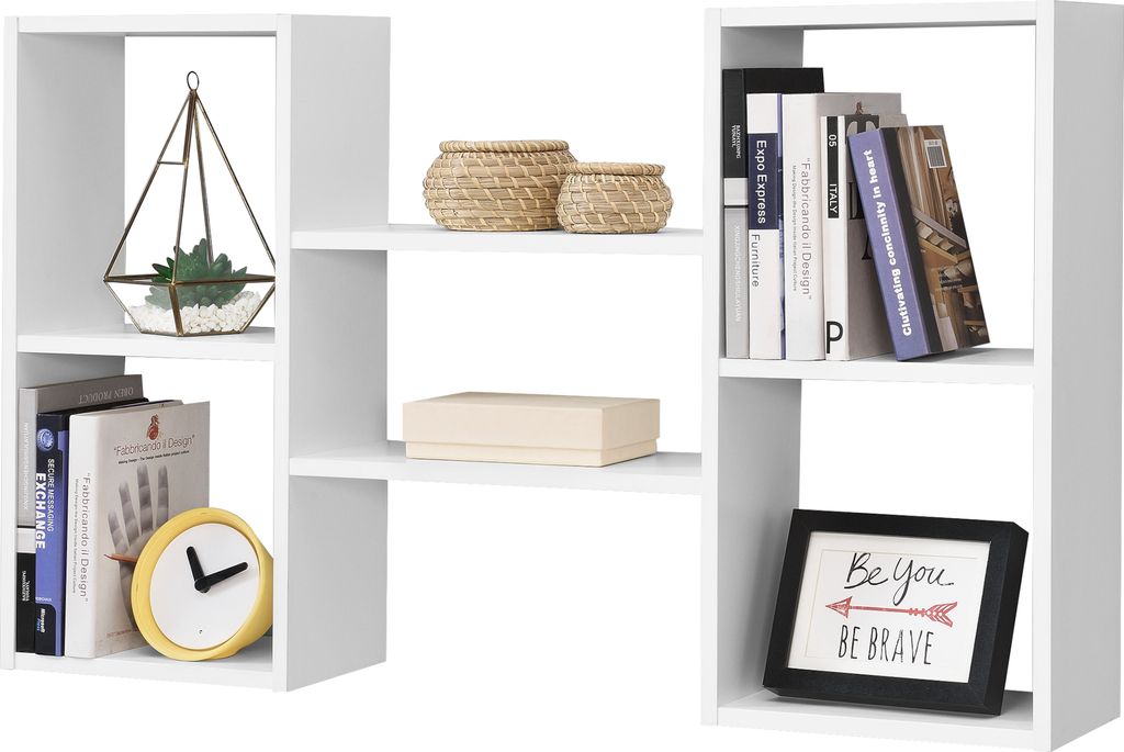 A white modular shelving unit with various decorative items and books placed on its shelves.