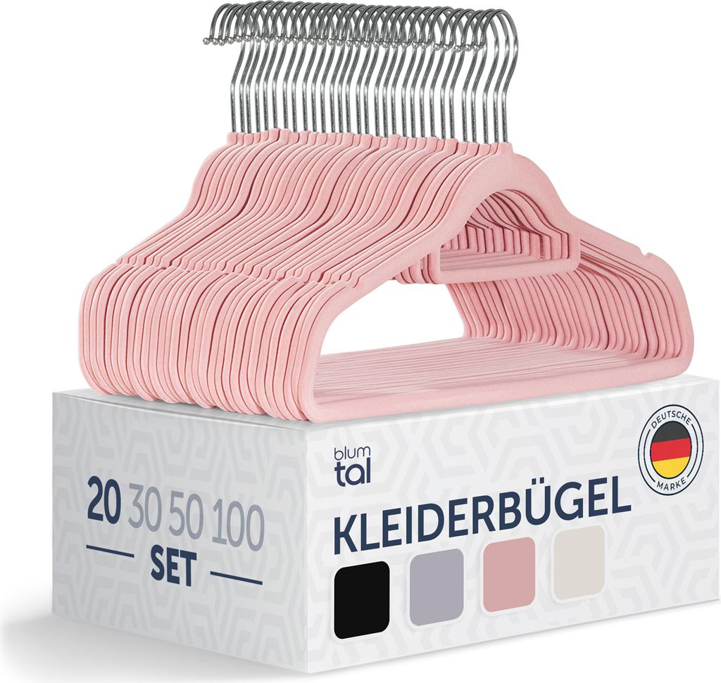 A stack of pink velvet clothes hangers on top of a product box, with the brand name and product details visible on the box.