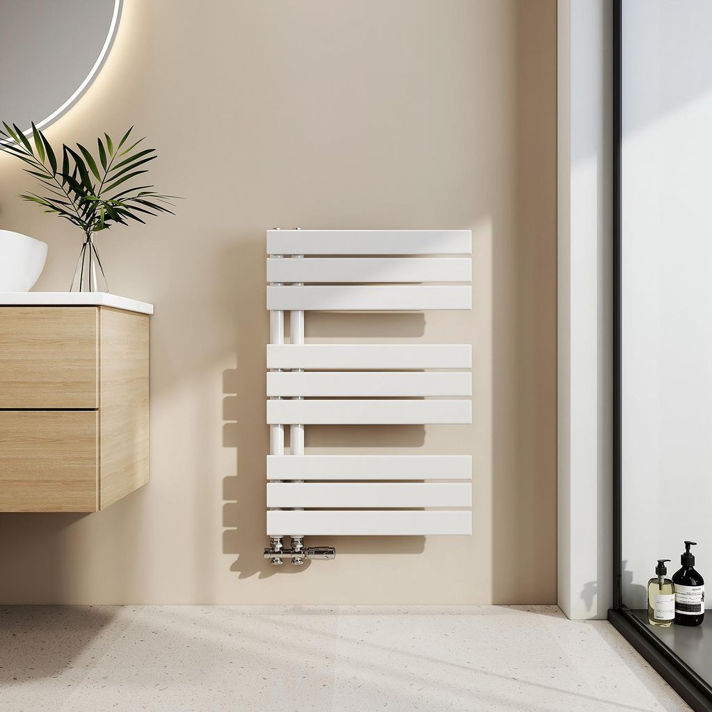 A modern bathroom setting with a white towel radiator, wooden vanity, and a round mirror.