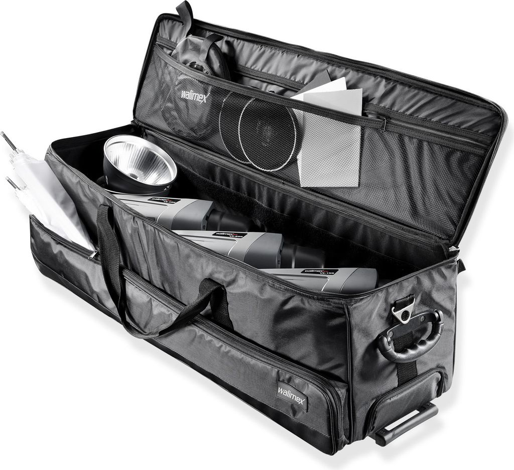 A black studio trolley bag is open, showing photographic equipment inside.