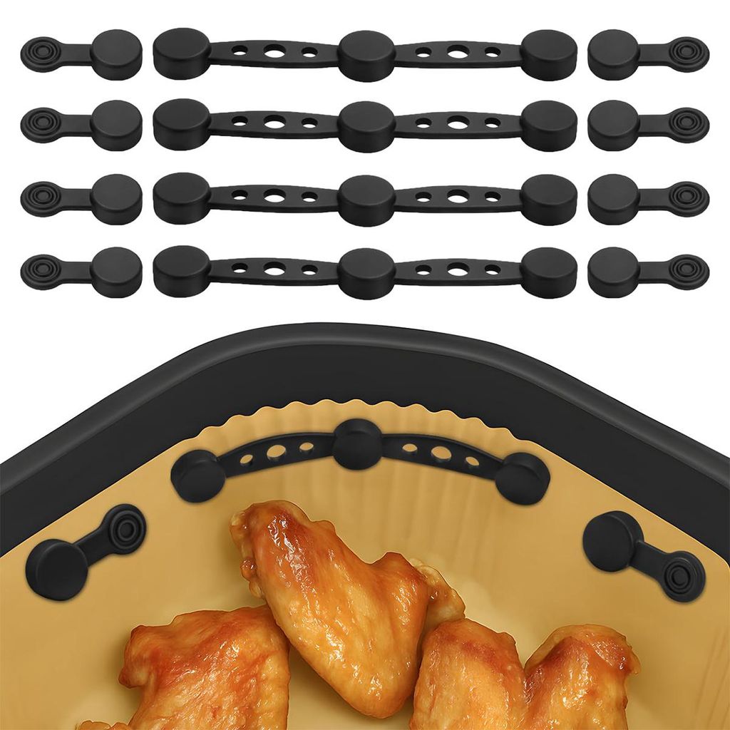 A set of black silicone magnets for an air fryer, shown with some chicken wings in the foreground.