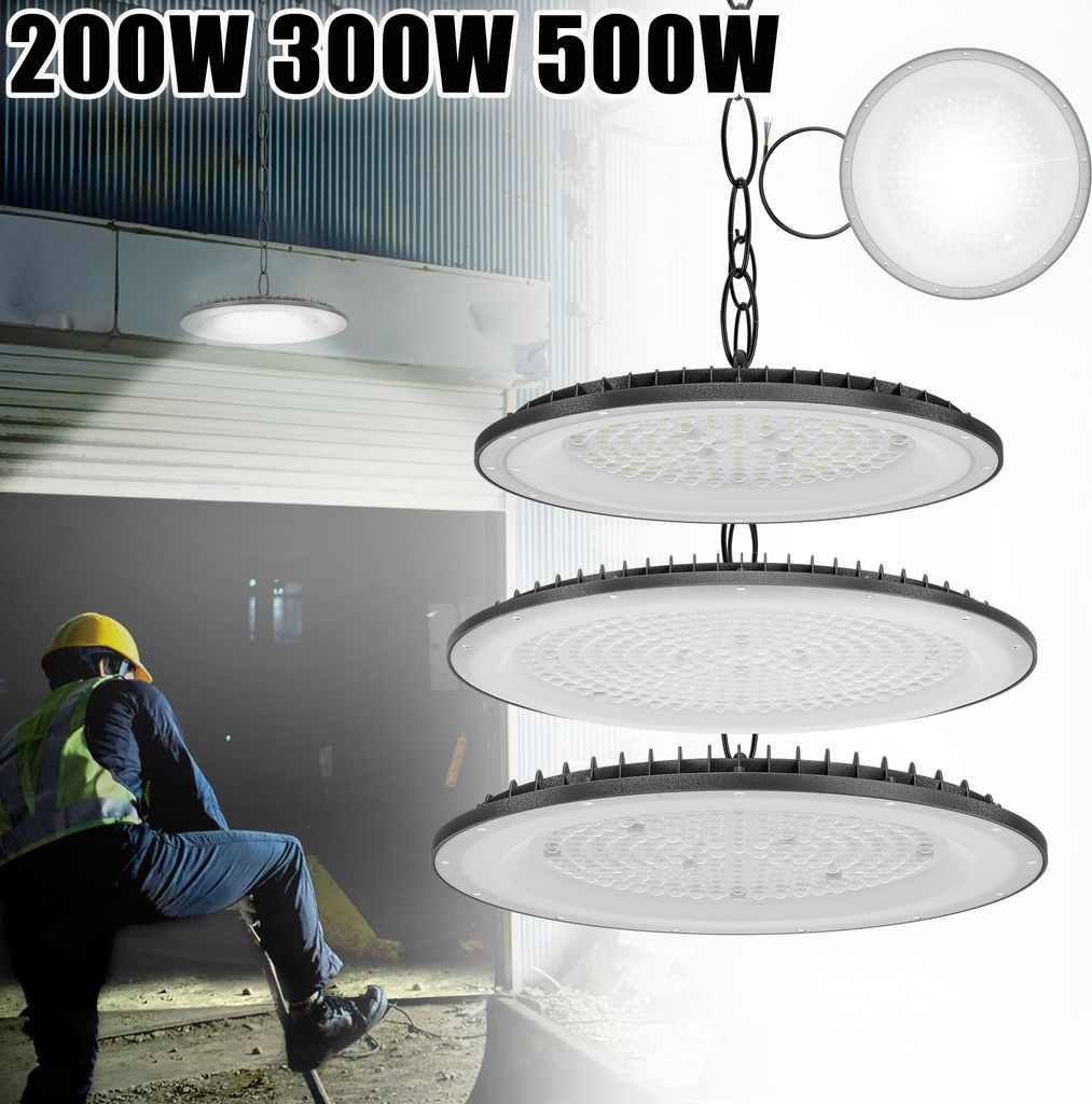 A worker in a yellow hard hat and safety vest is shown in the foreground, with three LED UFO high bay lights hanging in the midground and background. The lights are illuminated.