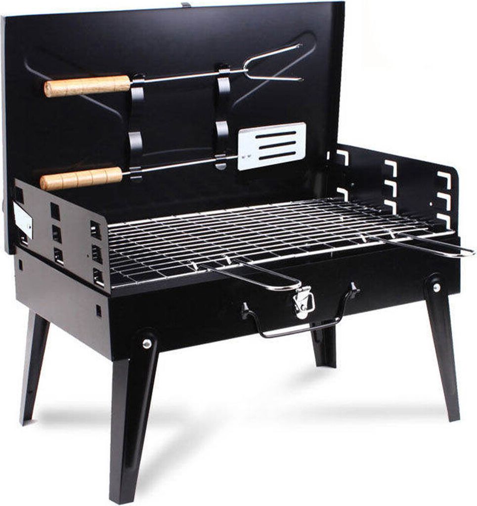 A black portable grill with its lid open, showing the cooking grate and two grilling tools.