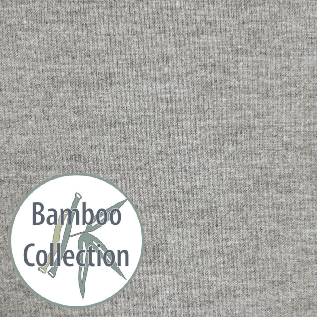 A close-up of grey fabric with a circular logo containing text and a bamboo illustration.