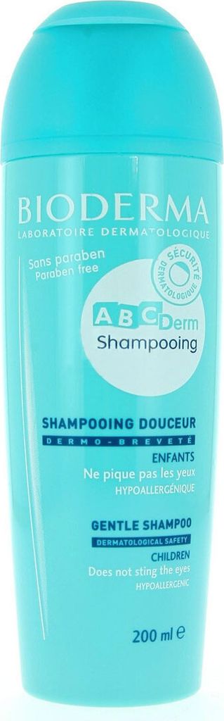 A turquoise bottle of Bioderma ABCDerm Shampooing is shown against a white background.