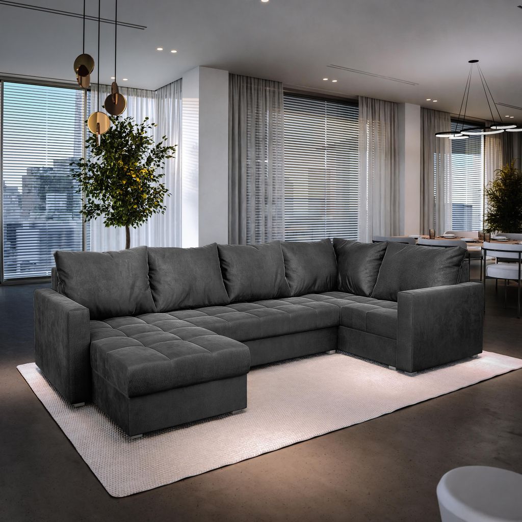 A spacious living room with a large sectional sofa, dining area, and large windows with blinds.