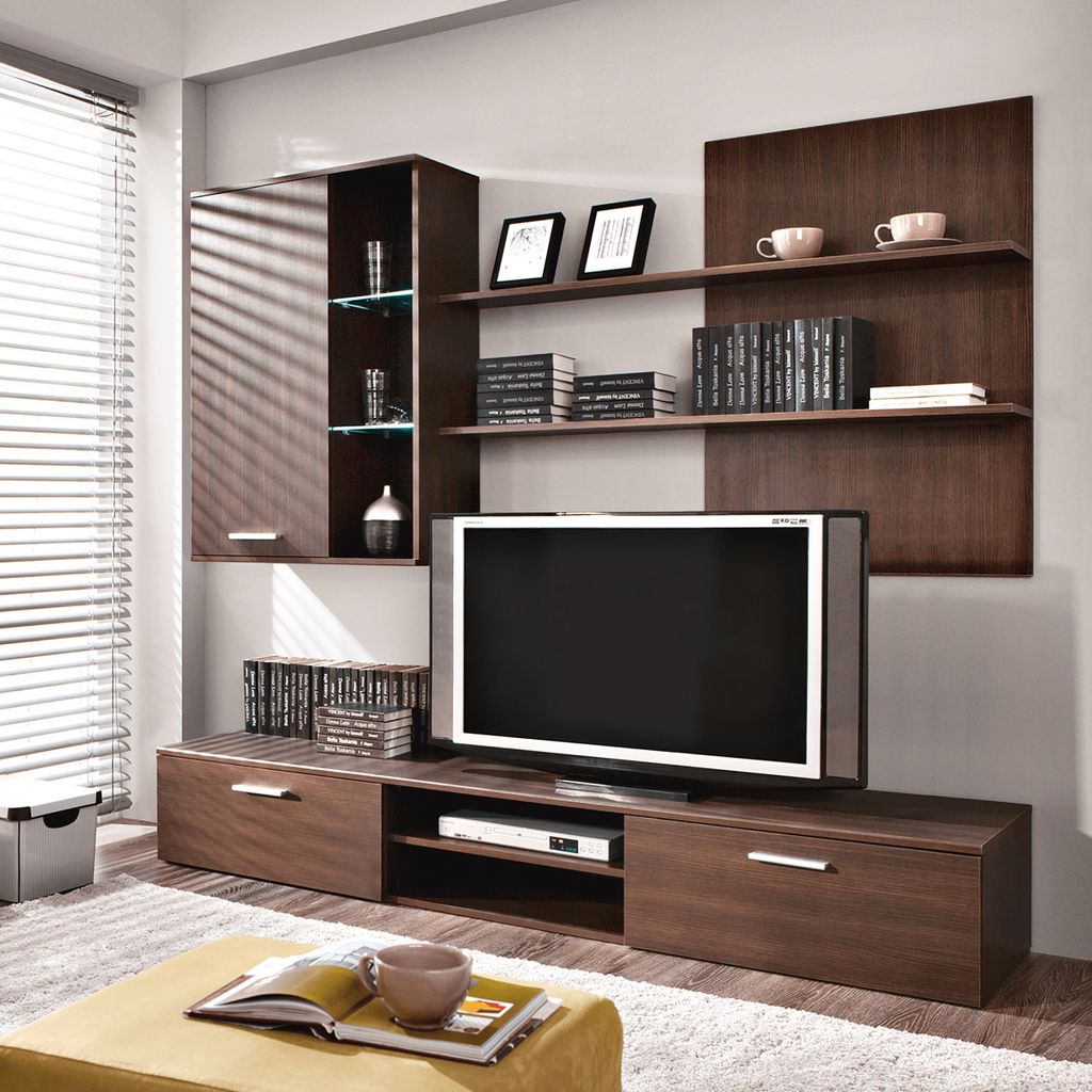 A modern living room entertainment center with a TV, shelves, and storage units.