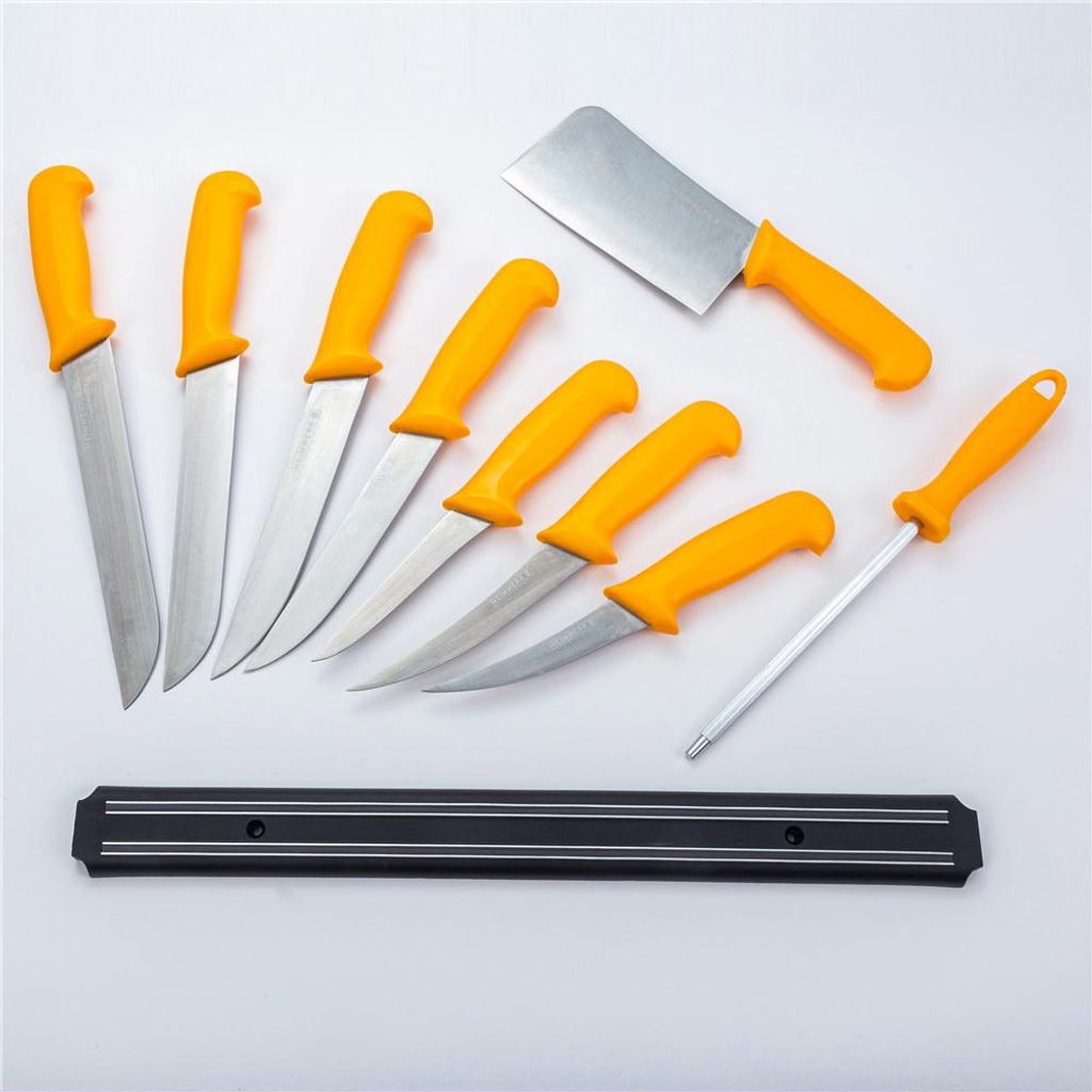 A set of kitchen knives and a sharpening steel arranged on a white background, with a magnetic knife strip below.