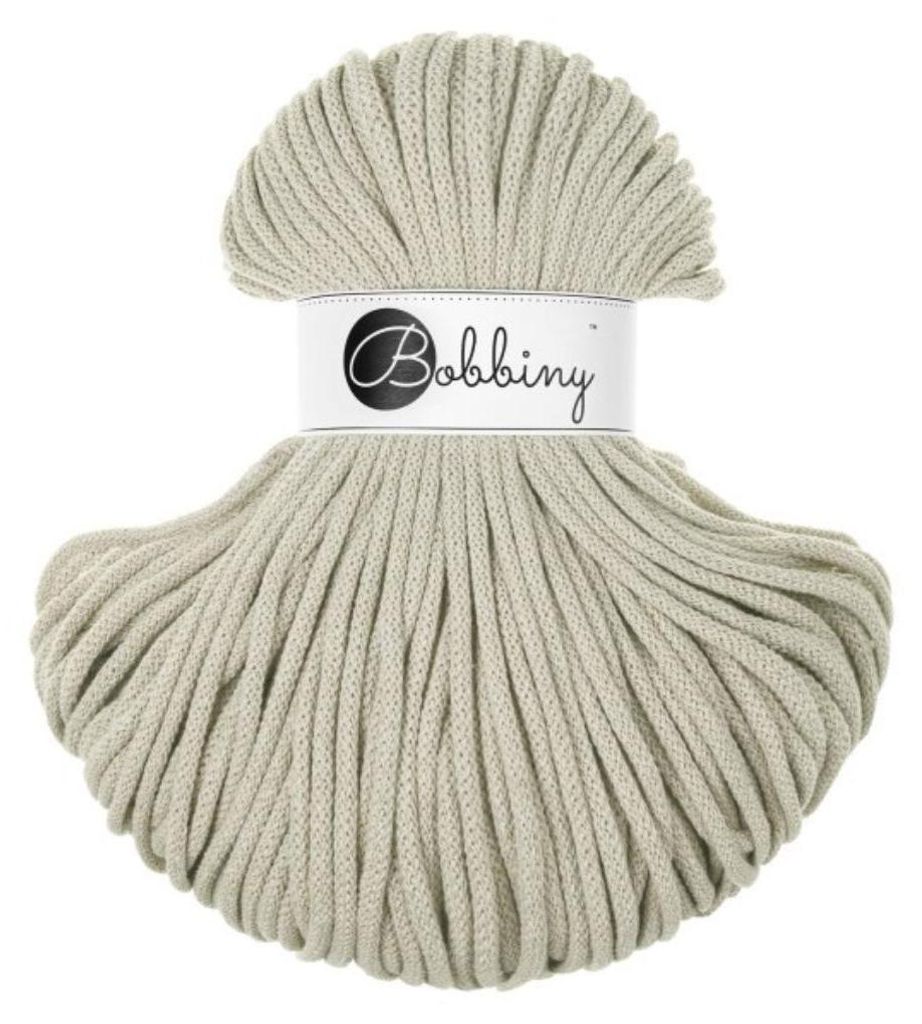 A ball of beige cord on a white background.