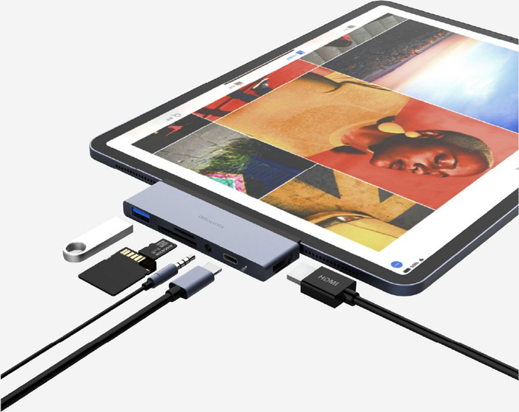 A tablet is connected to a USB-C hub, which is also connected to various accessories like an HDMI cable, SD card, and USB drive.