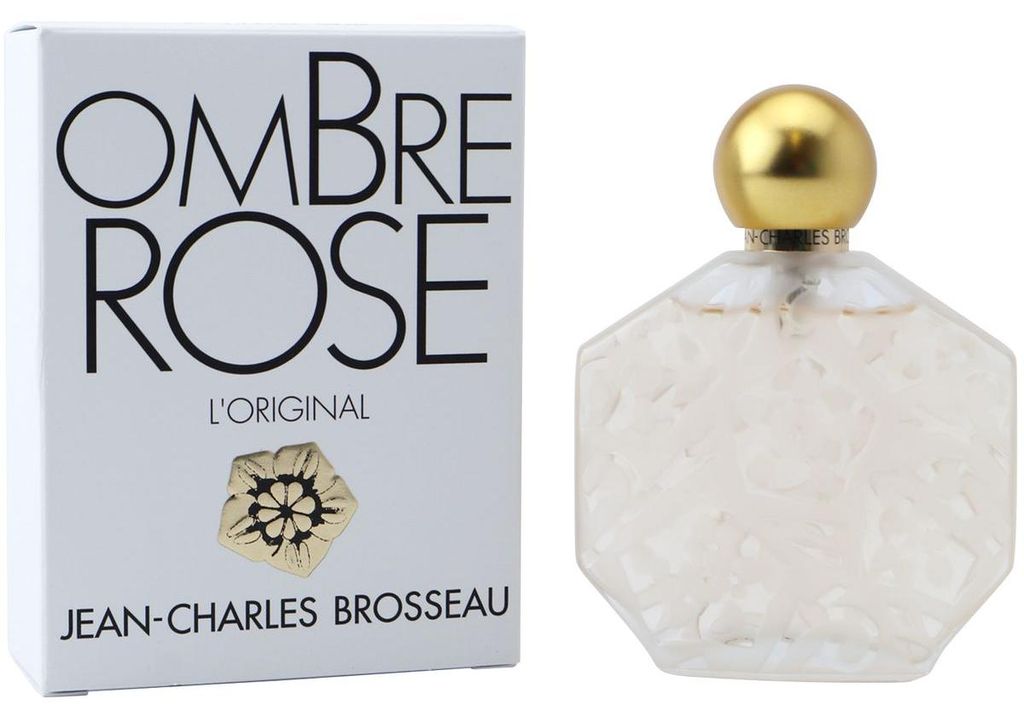 Achteckige Parfumflasche mit opak-weißer Reliefoberfläche und goldener Kugelkappe, daneben weiße Schachtel mit großem Ombre Rose Schriftzug in Schwarz.