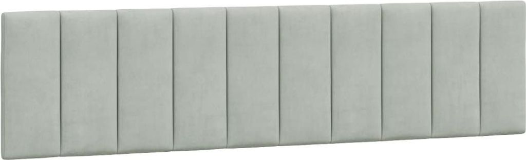 A light gray upholstered headboard with vertical tufting.