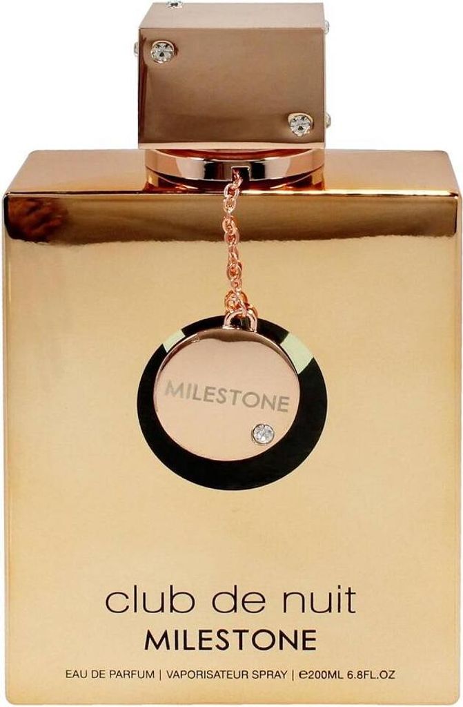 A close-up front view of a gold-colored perfume bottle with a decorative charm hanging from the cap.