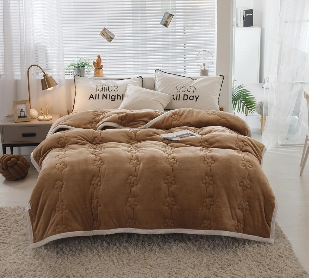 A bedroom scene with a bed made up with a brown comforter and pillows.