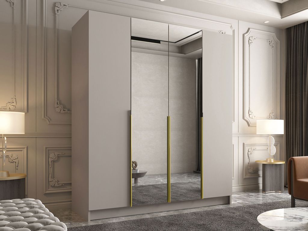 A modern wardrobe with mirrored doors and gold handles in a well-decorated room.