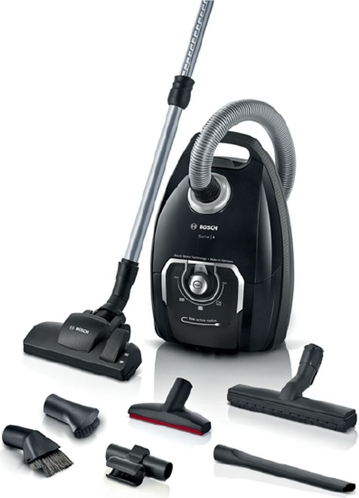A black Bosch bag vacuum cleaner with its various attachments displayed around it.