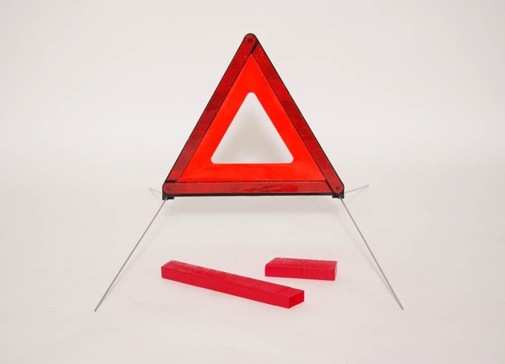 A red triangular warning sign with silver supports and two red rectangular blocks on a white background.