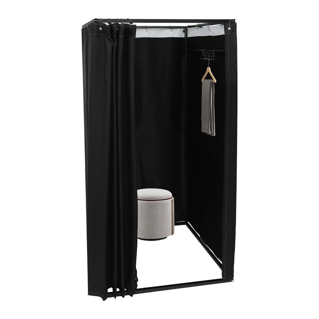 A black freestanding changing room with a stool and a scarf hanging on a hanger.
