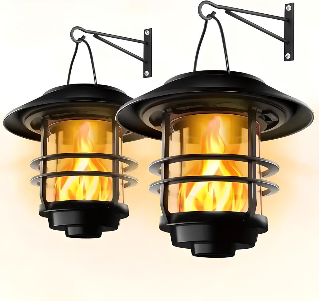 Two solar-powered lanterns with flickering flame effects are mounted on wall brackets.