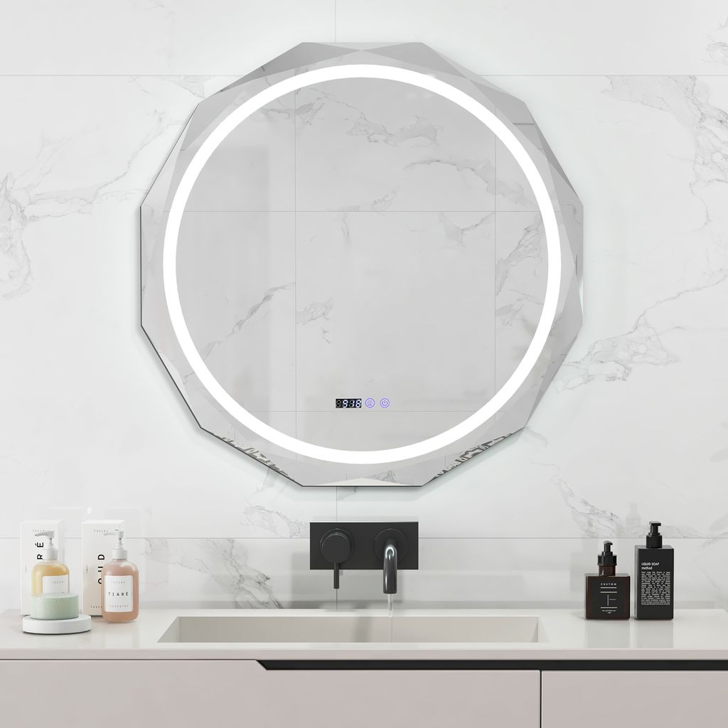 A modern bathroom vanity with a sink, faucet, and a large LED mirror mounted on a marble-tiled wall.