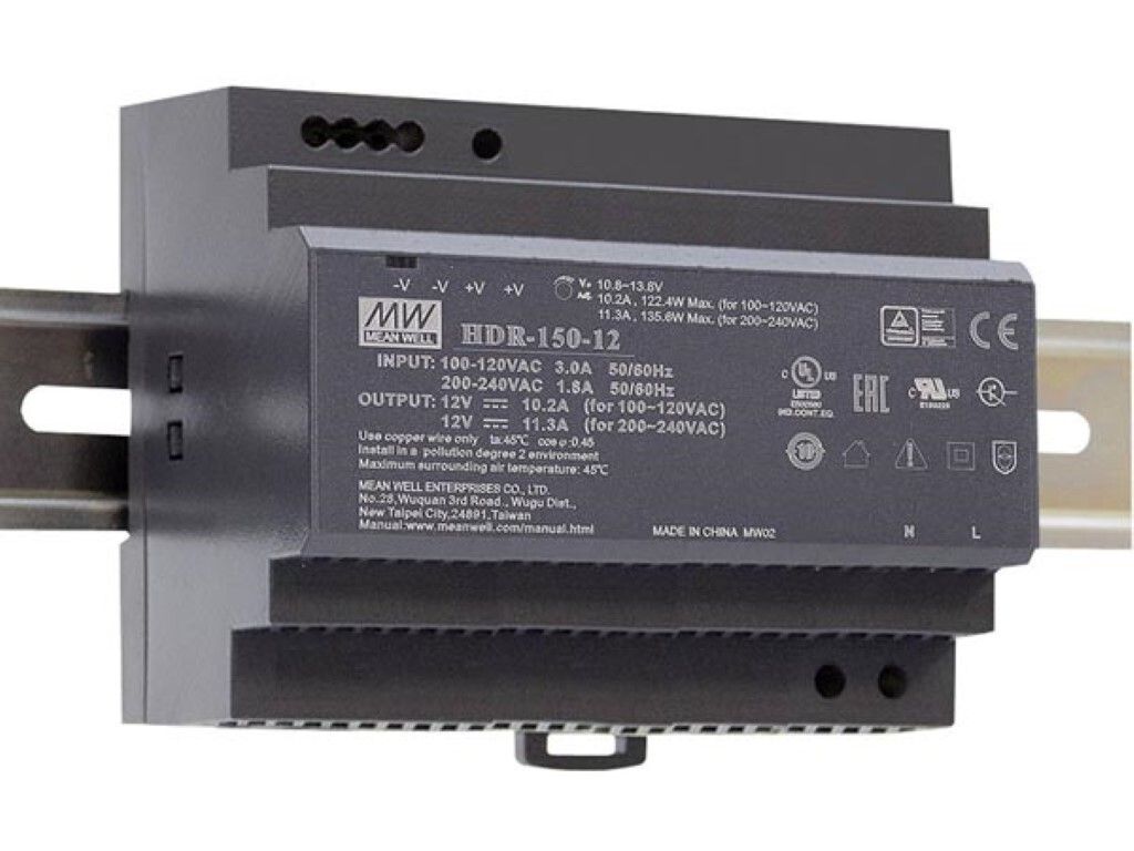 A gray industrial power supply unit mounted on a DIN rail.