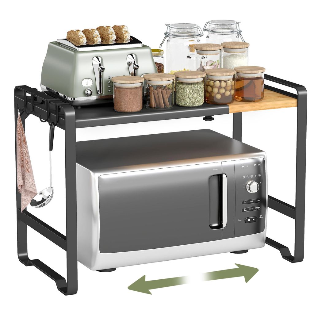 A kitchen counter with a microwave and an expandable shelf above it.