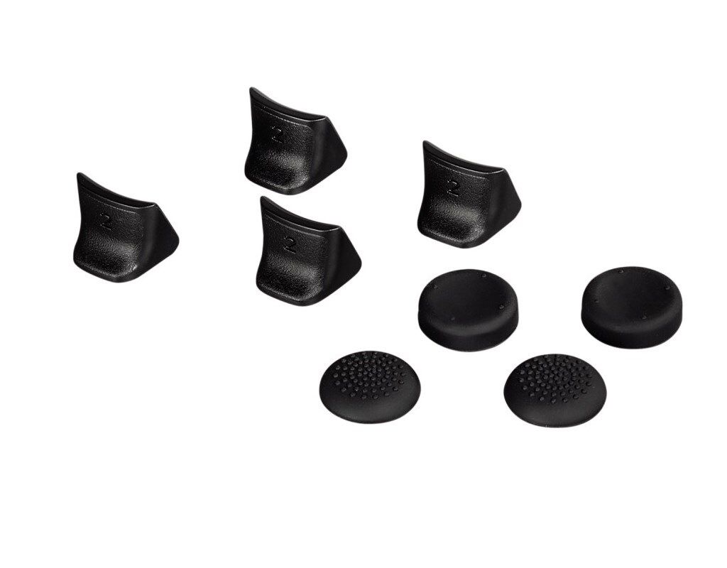 A collection of black analog stick and trigger attachments for a game controller, laid out on a white background.