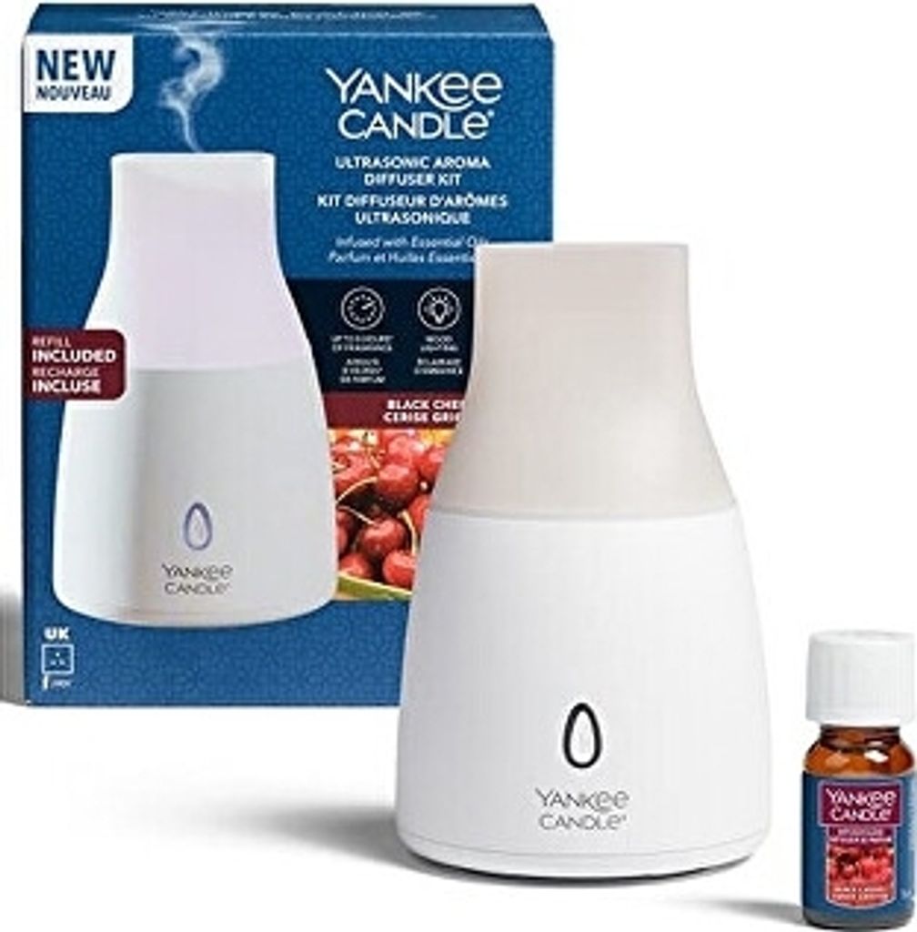 A Yankee Candle Ultrasonic Aroma Diffuser Kit with a bottle of Black Cherry essential oil, shown with its packaging.