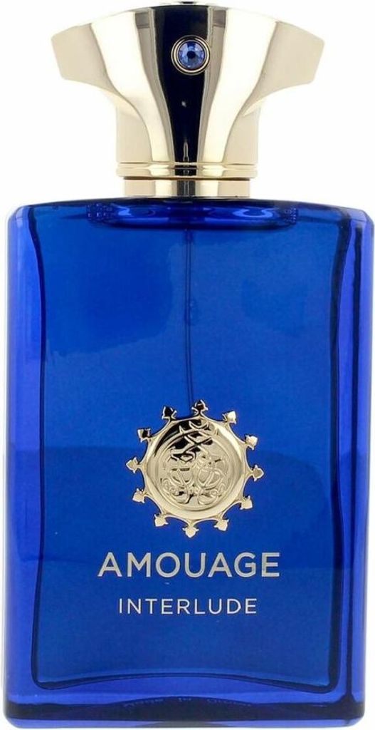 A close-up, front-facing studio shot of a blue glass perfume bottle with a gold cap and a gold emblem on the front.
