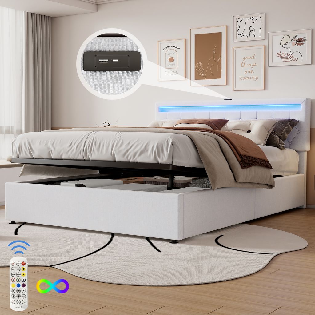 A white upholstered bed with a tufted headboard featuring LED lighting, shown with the storage compartment open. A remote control for the lighting is visible in the foreground.
