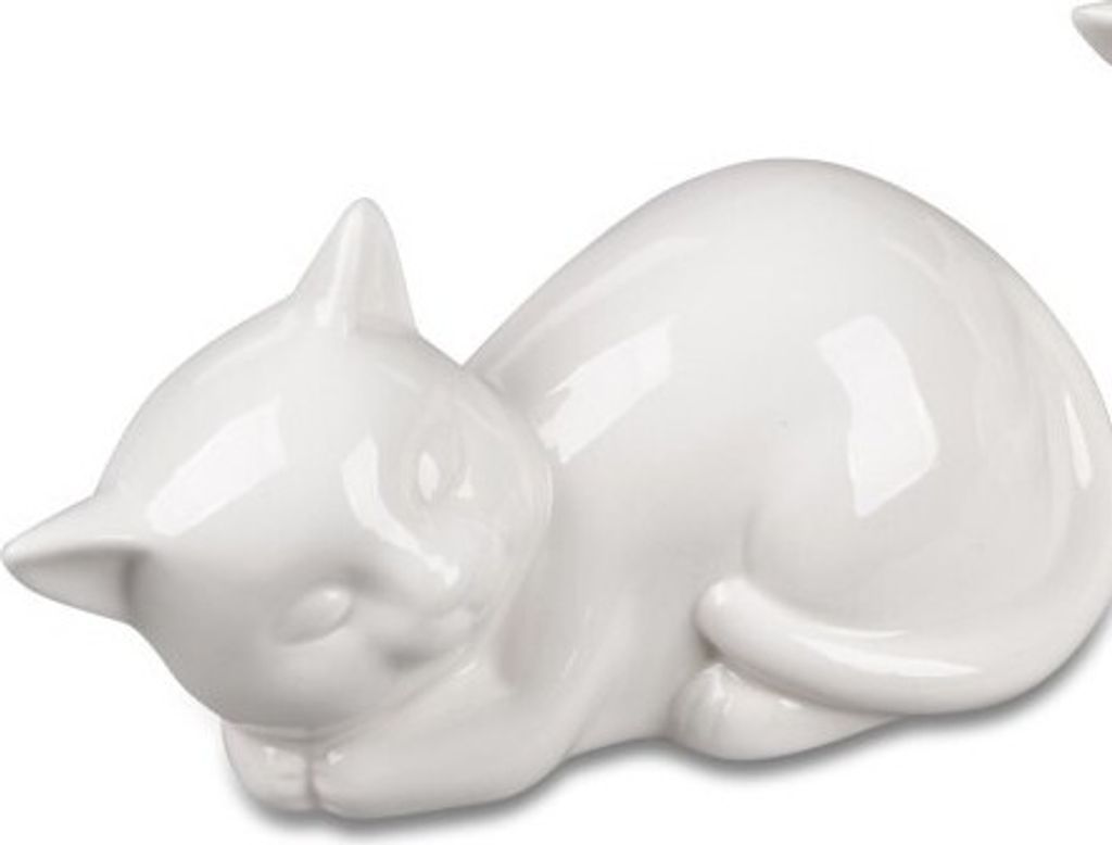 A white ceramic cat figurine lying down on a white background.