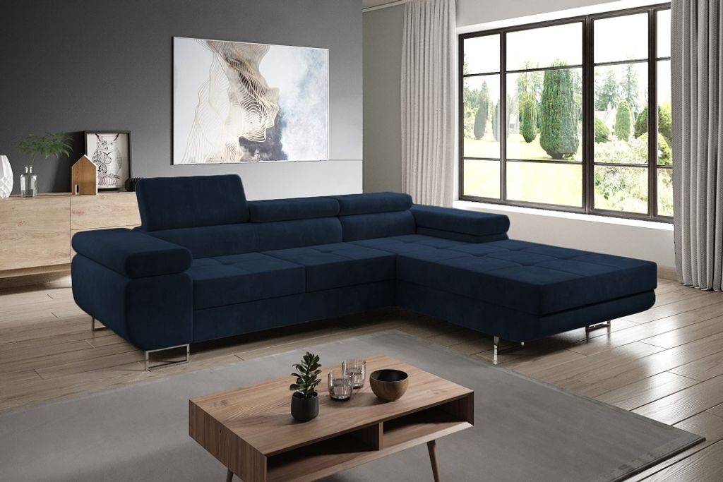 A modern living room with a navy blue sectional sofa, a coffee table, and a large window overlooking a garden.
