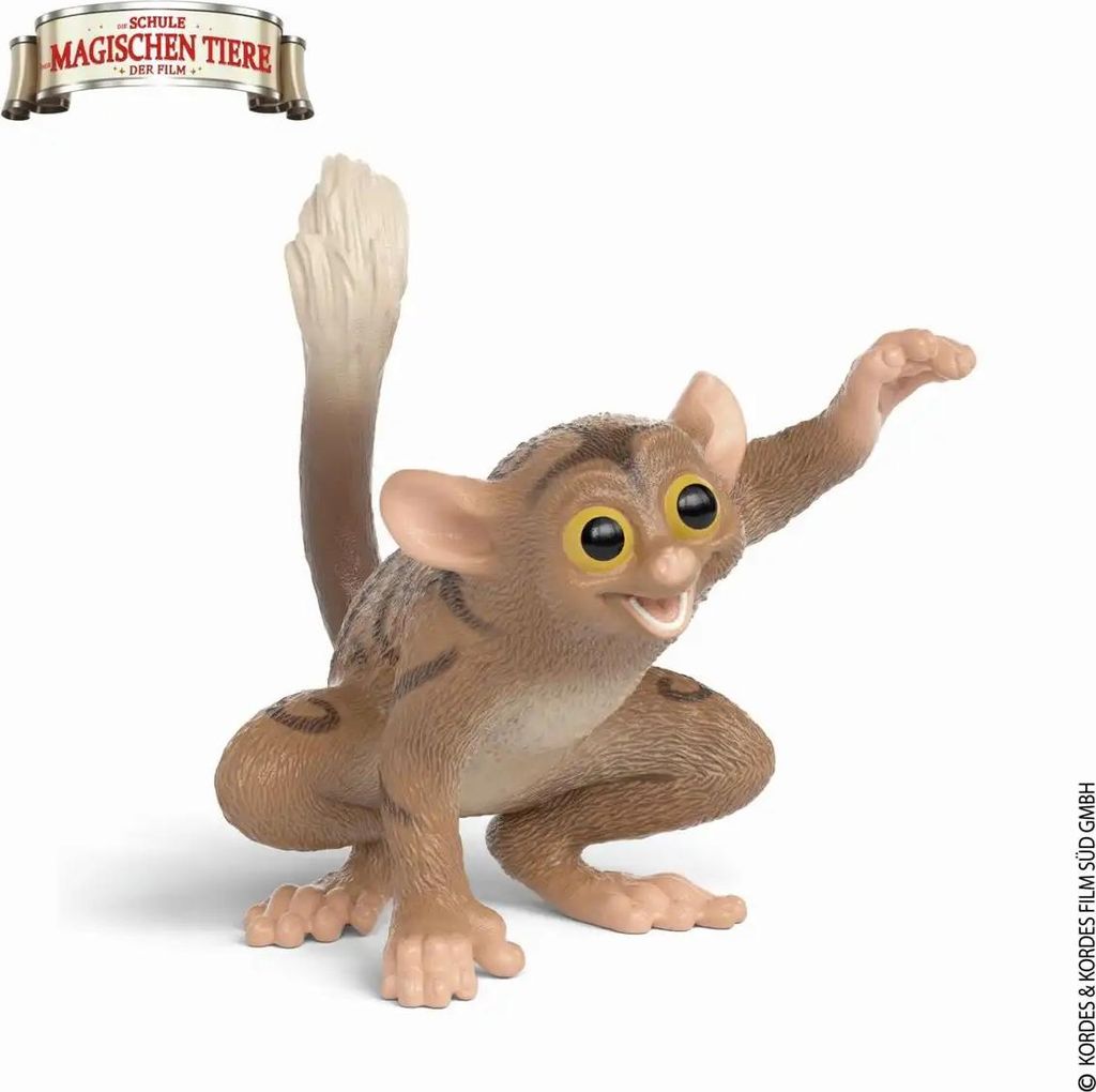 A toy figurine of a tarsier monkey posed on a white background.
