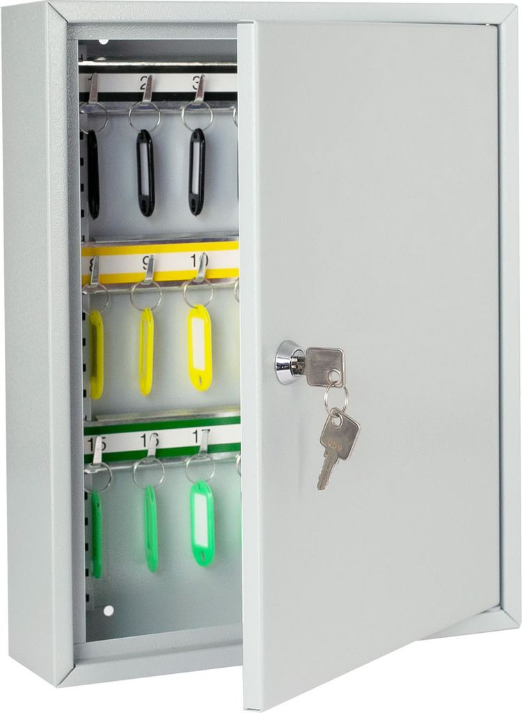 A light gray metal key cabinet with its door open, revealing multiple hooks for keys. Some keys with yellow and green tags are visible.